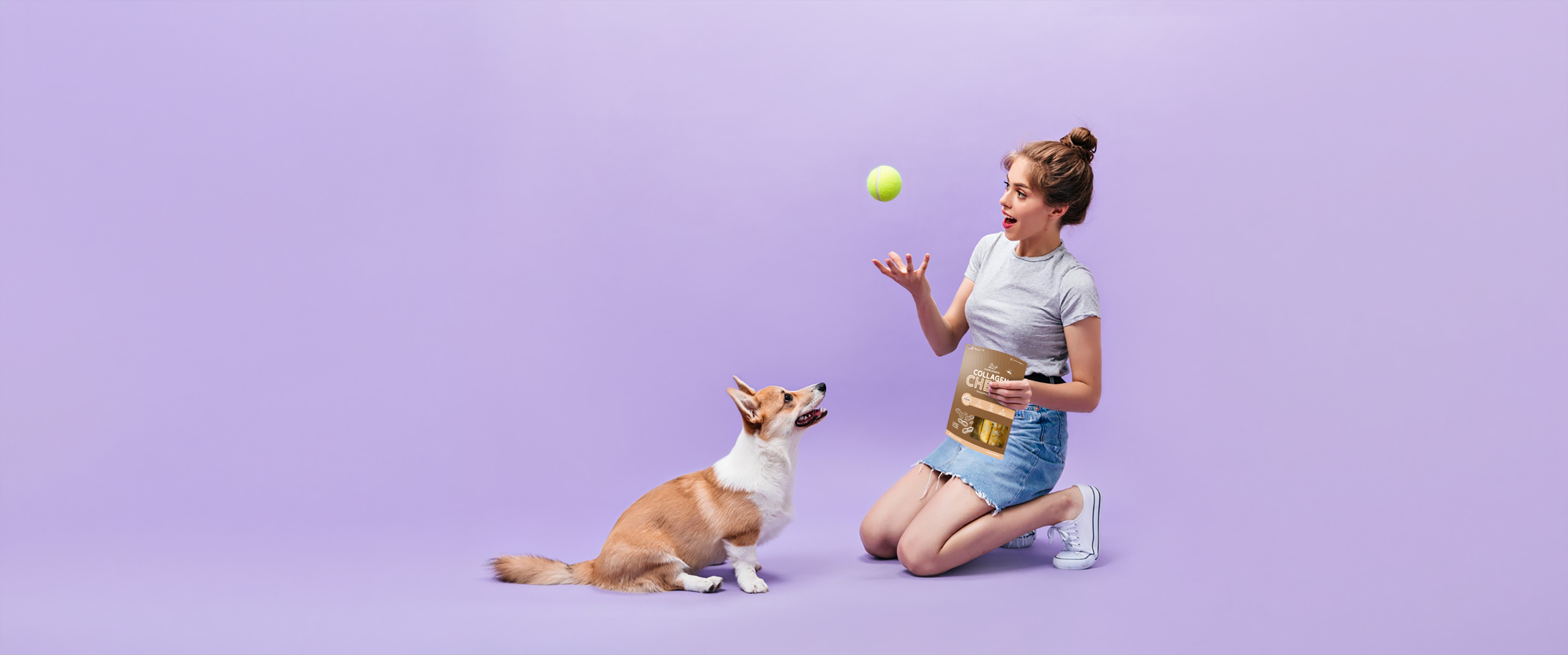Woman kneeling with a corgi while holding a bag of collagen chews